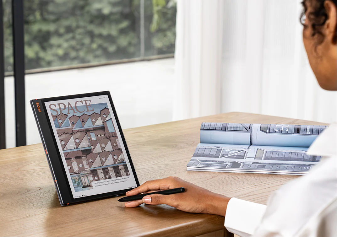Professional using a BOOX e-reader in a business workspace setting